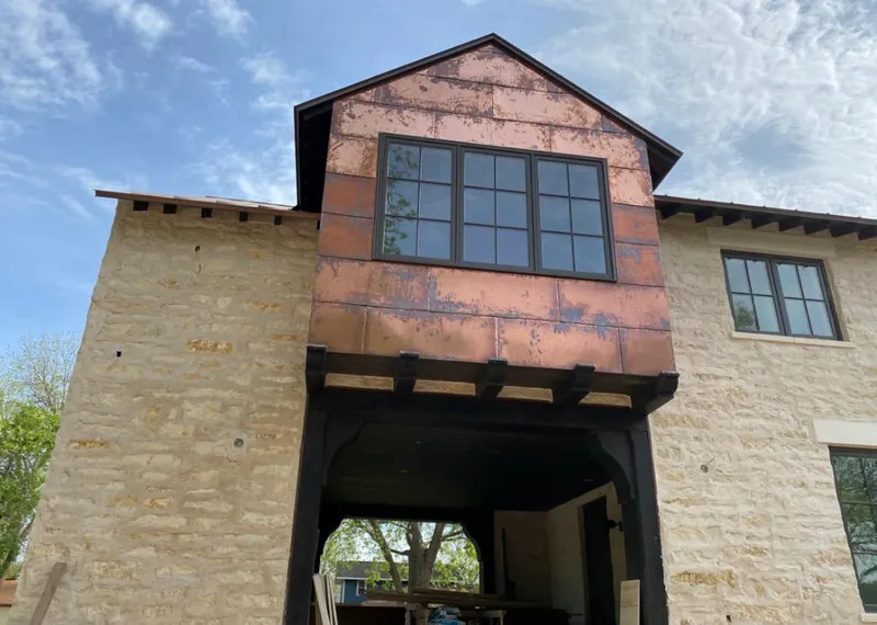 Copper metal panel facade on a stone building for Roof Repair in Glendale