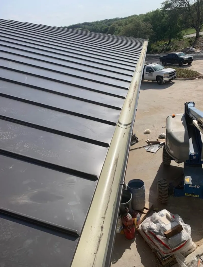 Standing seam panel and gutter detail on a metal roofing jobsite in Glendale